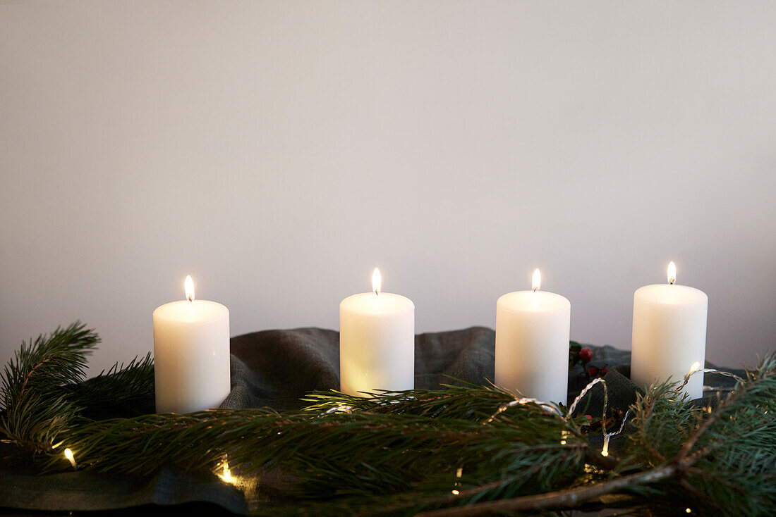 Christmas candles among conifer branches