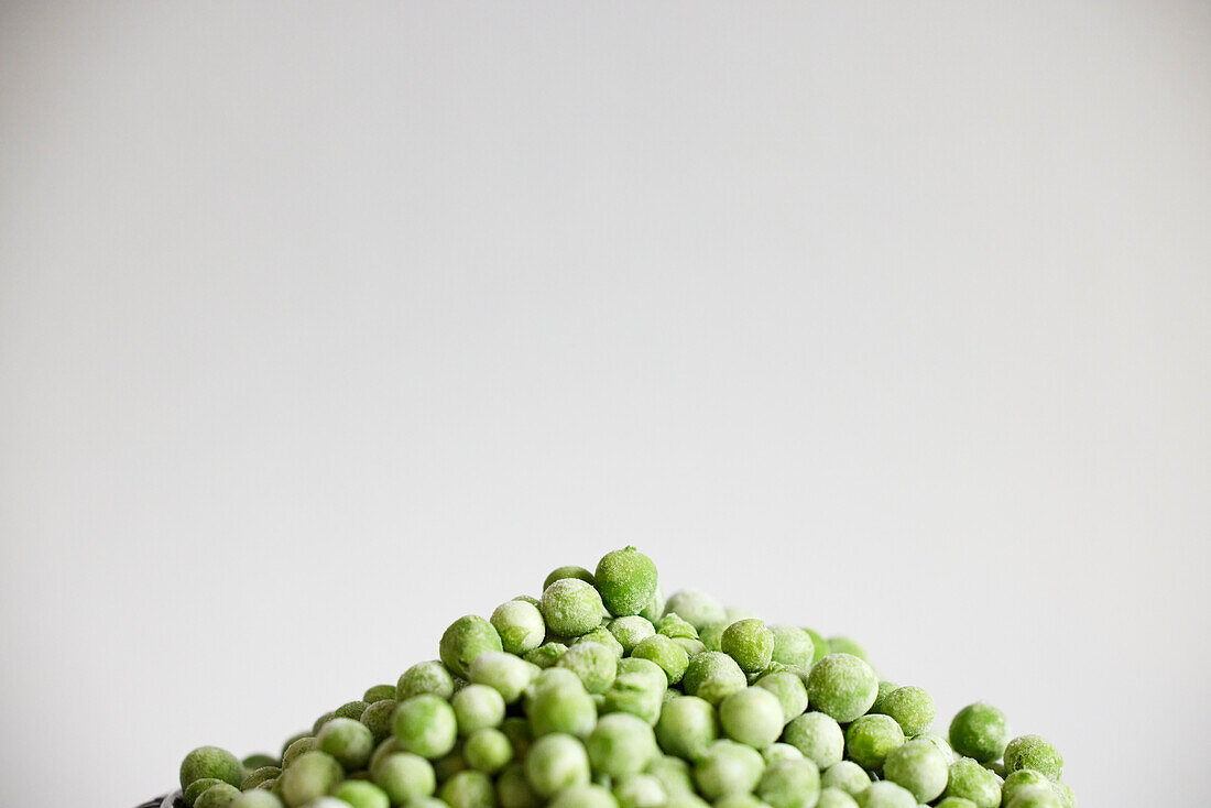 Heap of peas against gray background