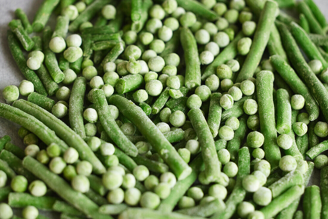 Heap of frozen green beans and peas