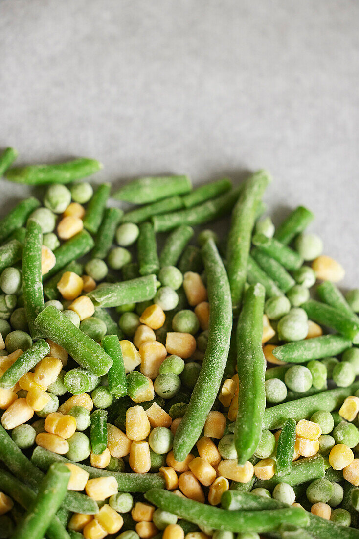 Heap of frozen green beans, peas, and corn