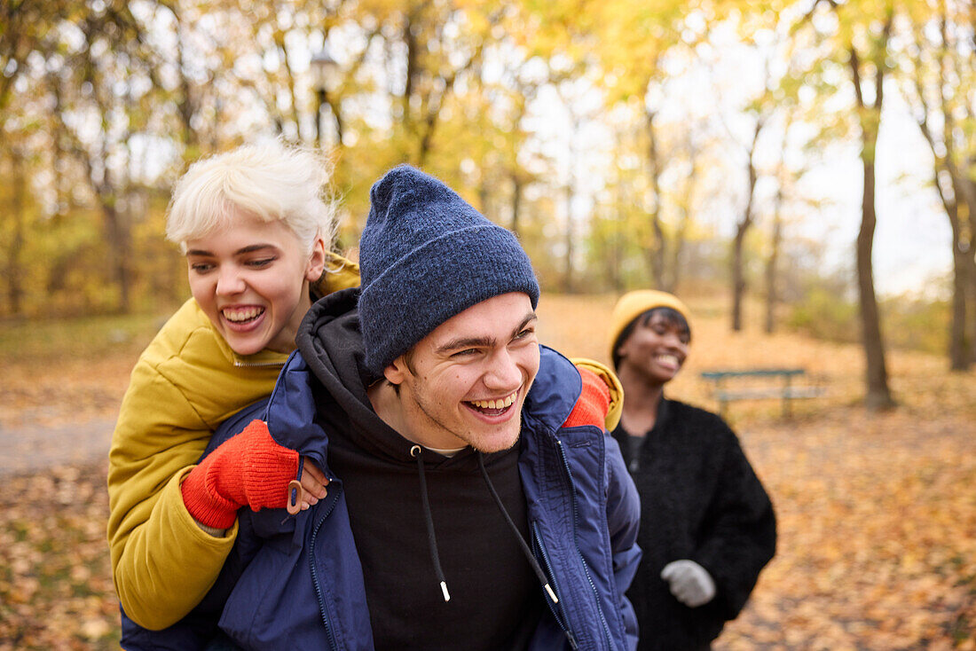 Happy young friends having autumn walk