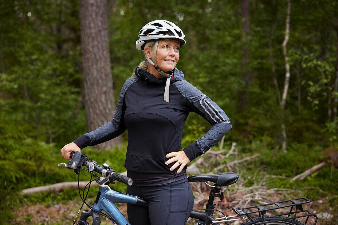 Smiling female cyclist looking away