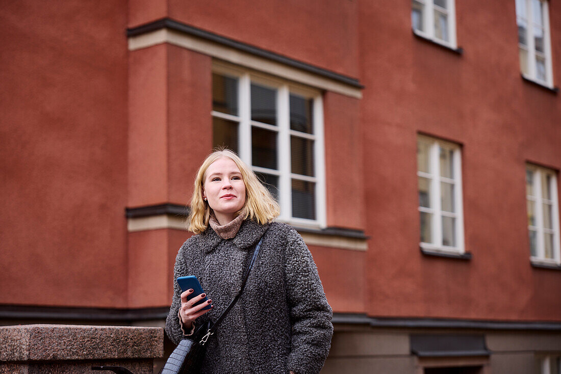 Woman using her cell phone while walking