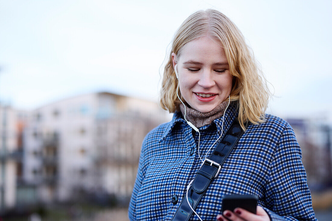 Smiling woman using cell phone