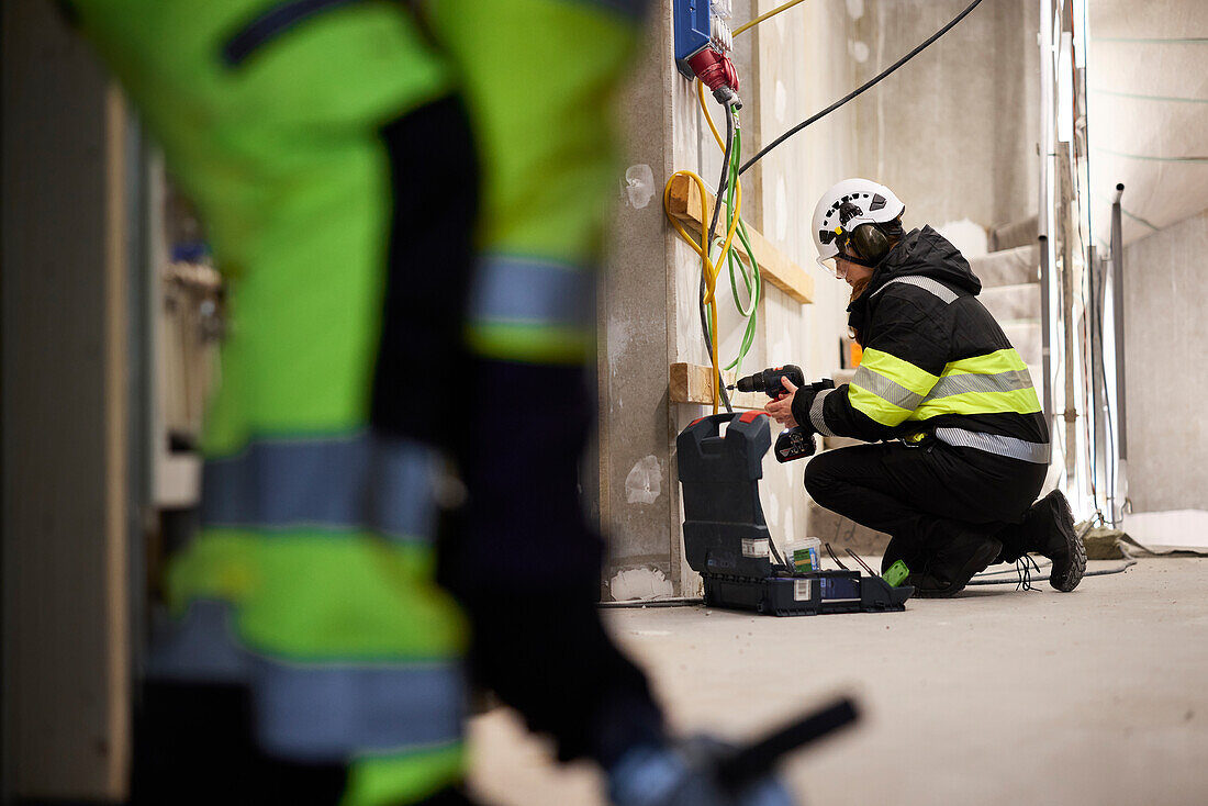 Construction worker using electric drill