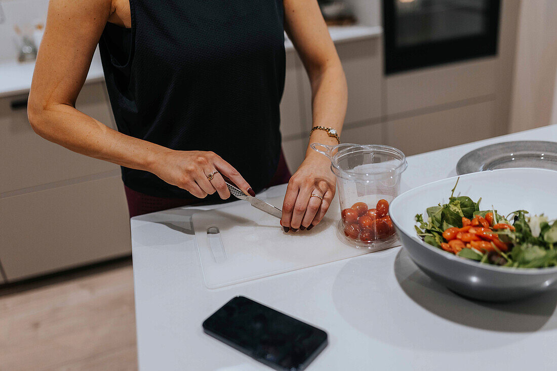 Mid section of woman preparing food in kitchen