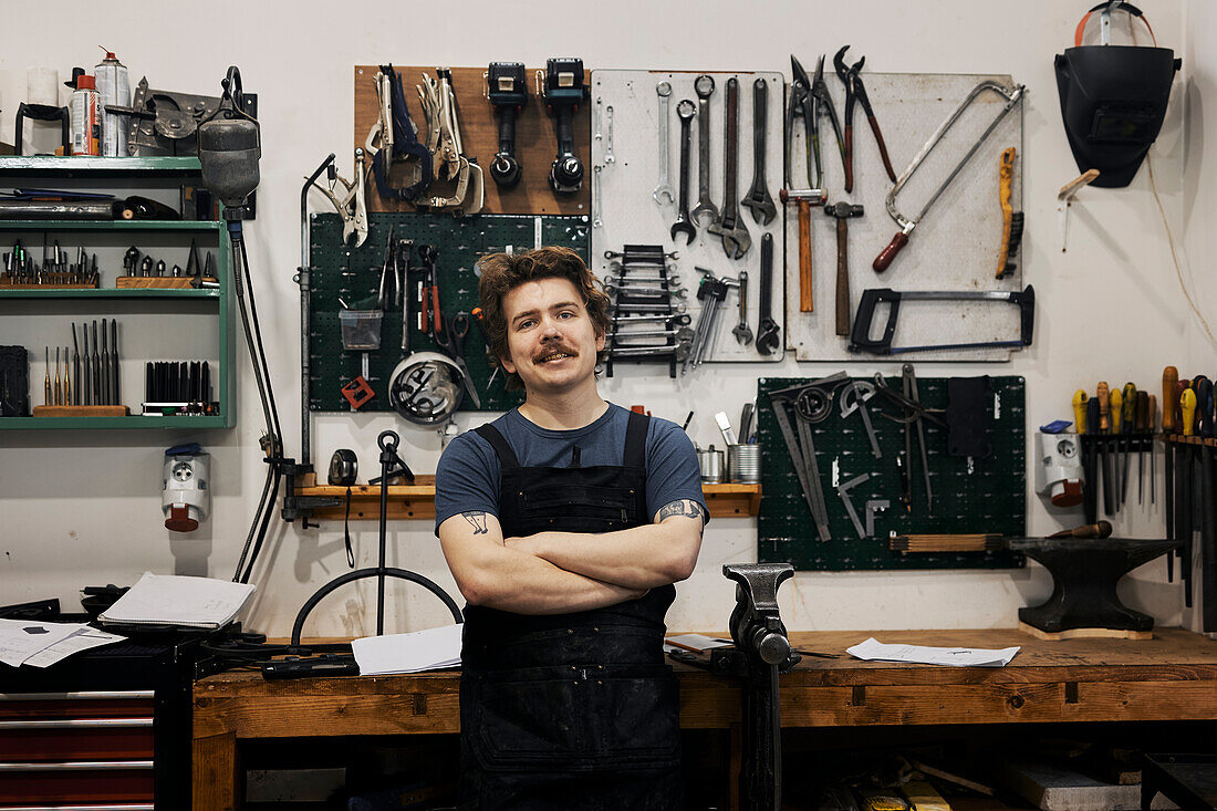 Blacksmith posing in his workshop