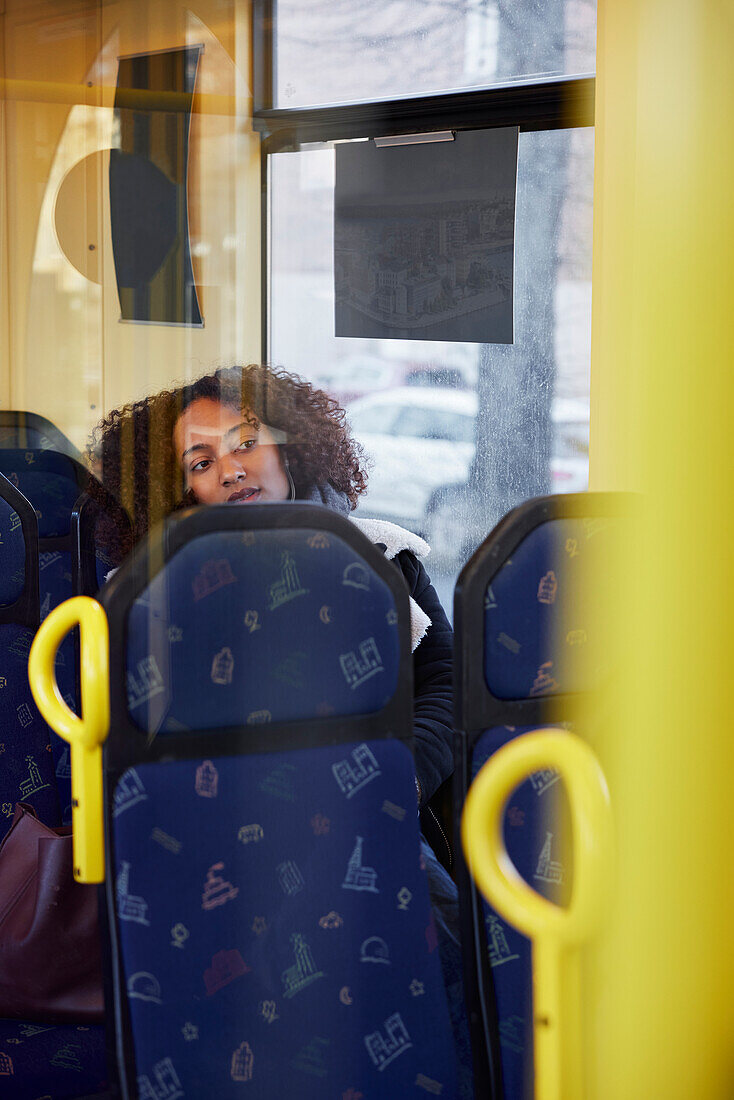 Young woman sitting in bus