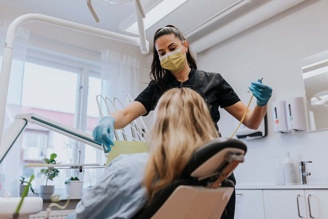 Female dentist with patient in dentist's office