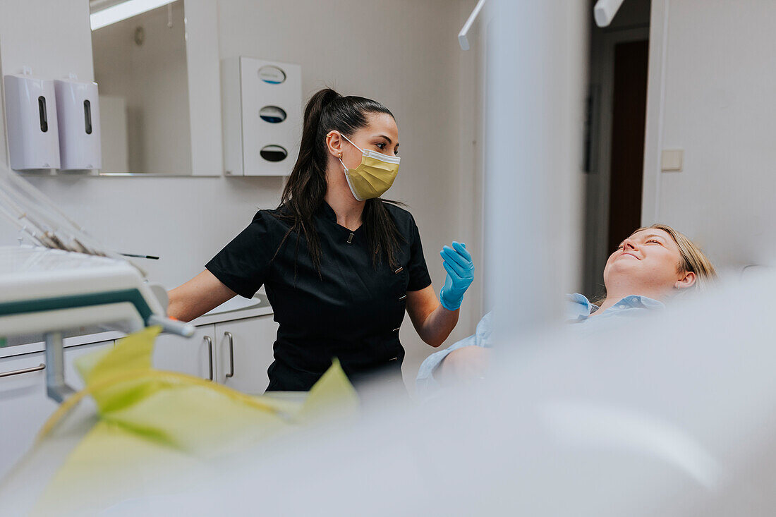 Female dentist with patient in dentist's office