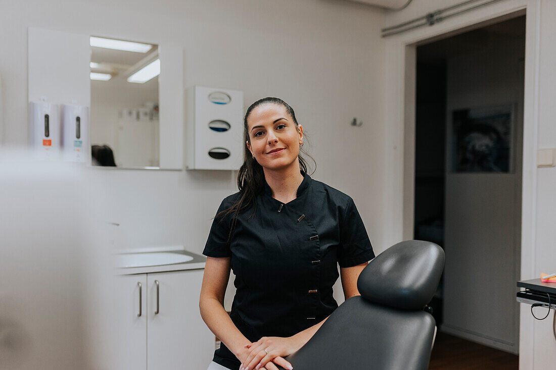 Female dentist standing in office