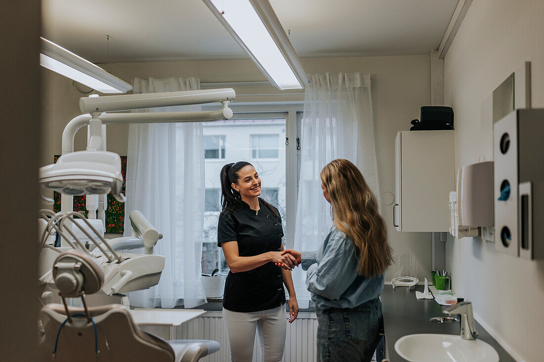 Female dentist with patient in dentist's office