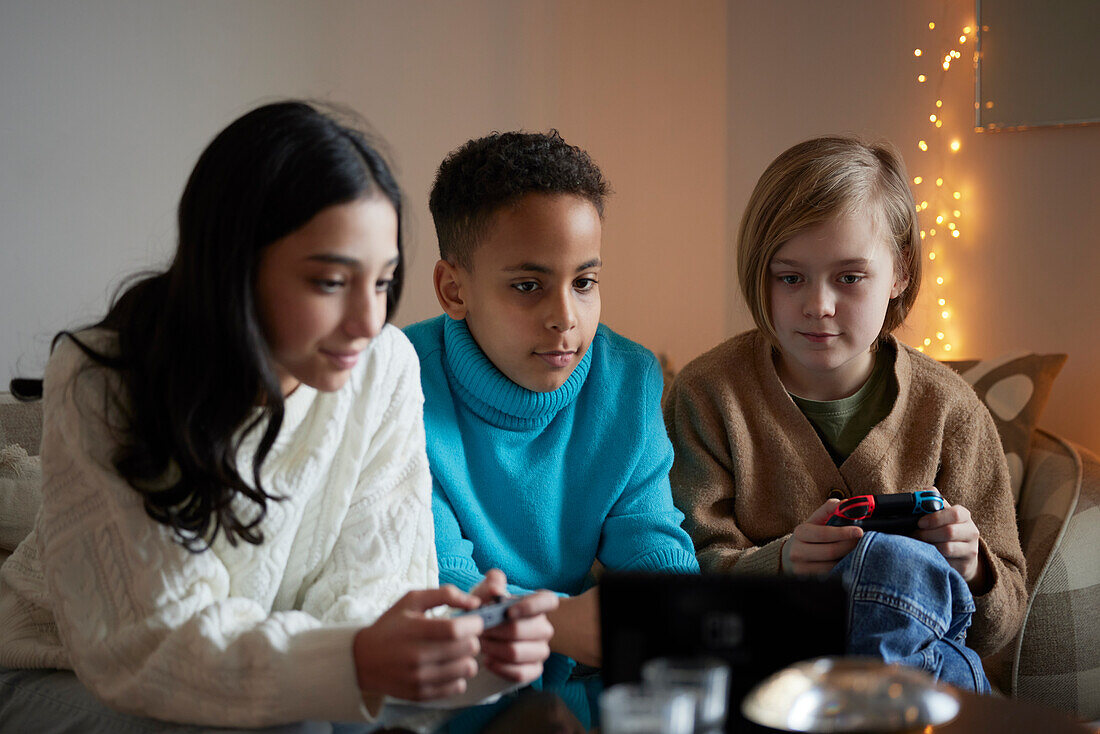 Children playing video games at home