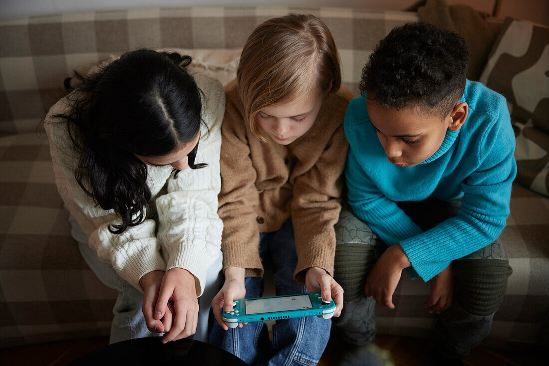 Children playing video games at home