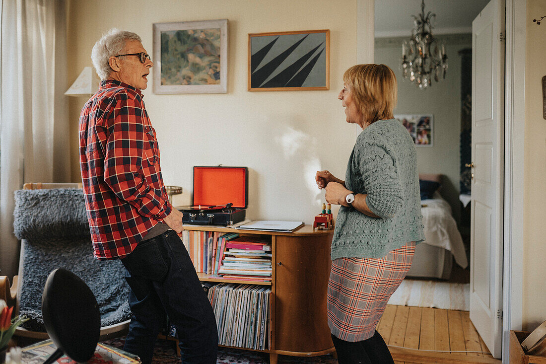 Senior couple dancing at home