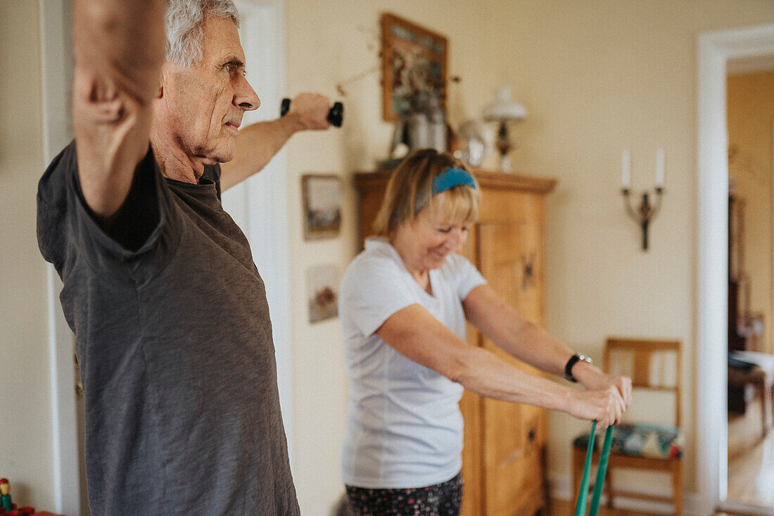 Senior couple exercising at home