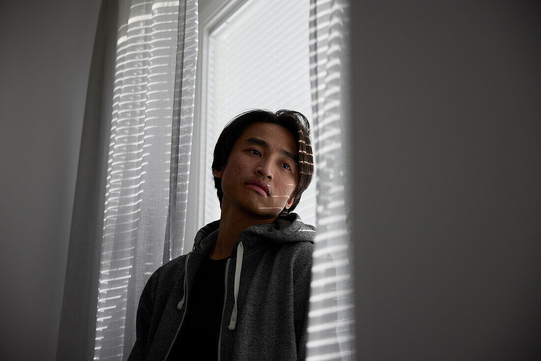 Man standing in front of window