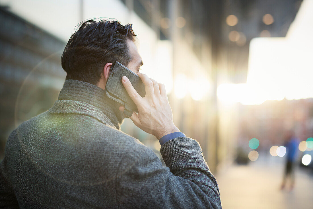 Businessman talking on phone outdoors