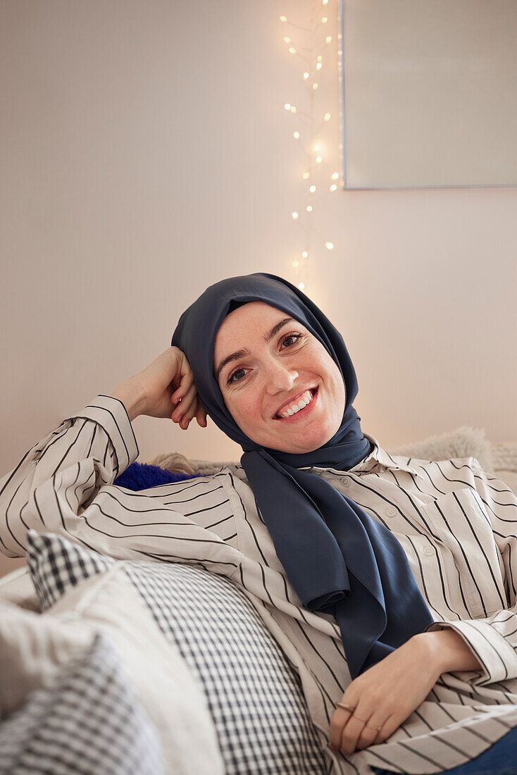 Woman on sofa looking at camera