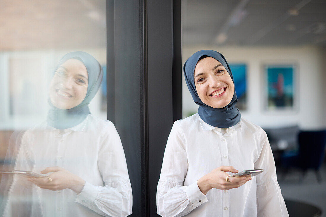 Portrait of smiling businesswoman in hijab