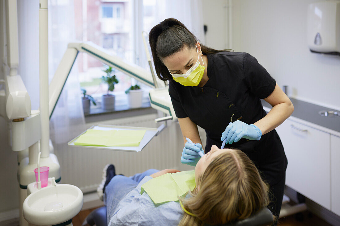 Female dentist with patient in office