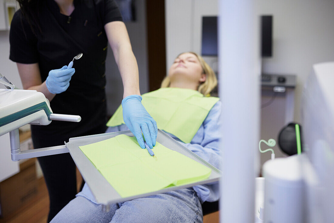 Female dentist with patient in office