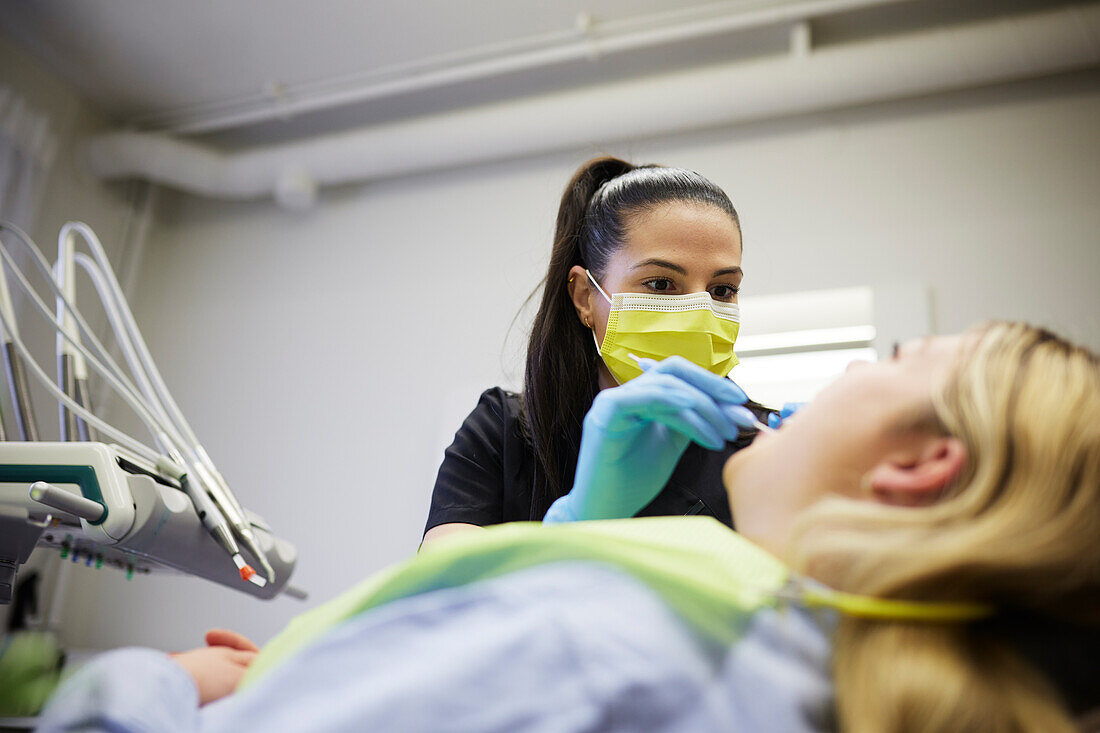 Female dentist with patient in office