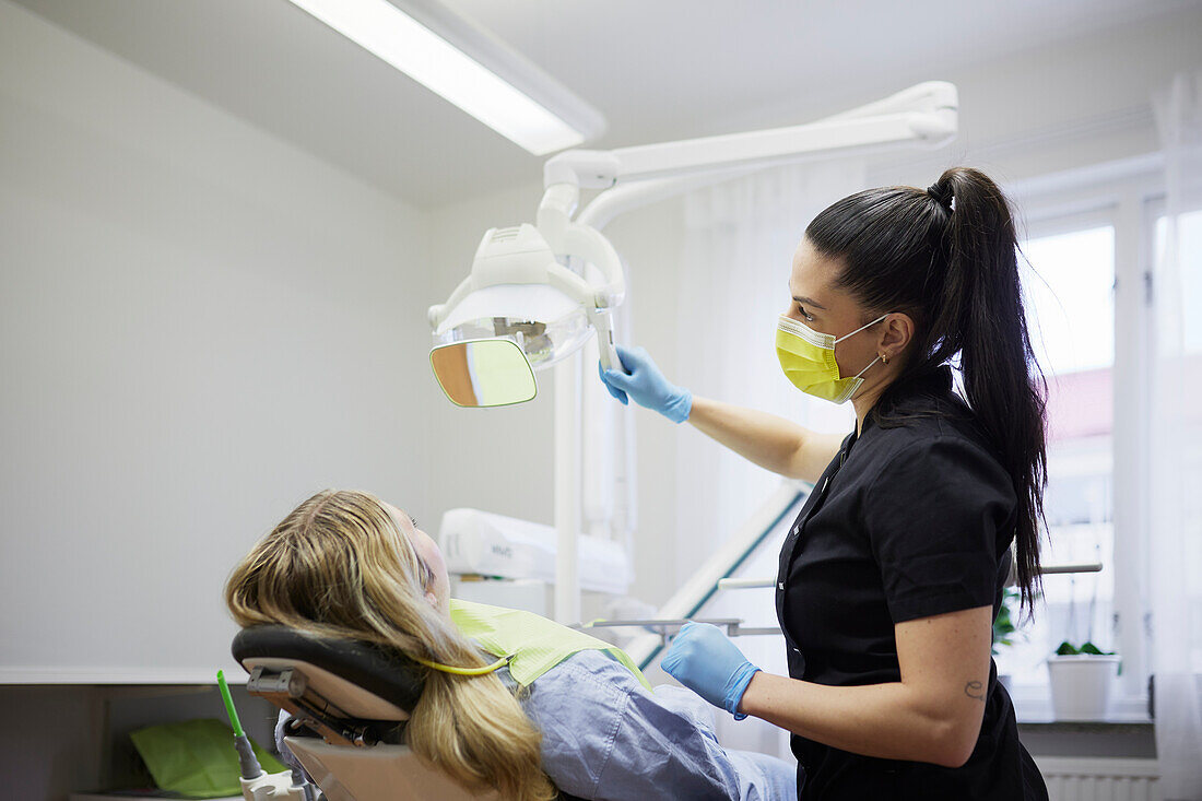 Female dentist with patient in office