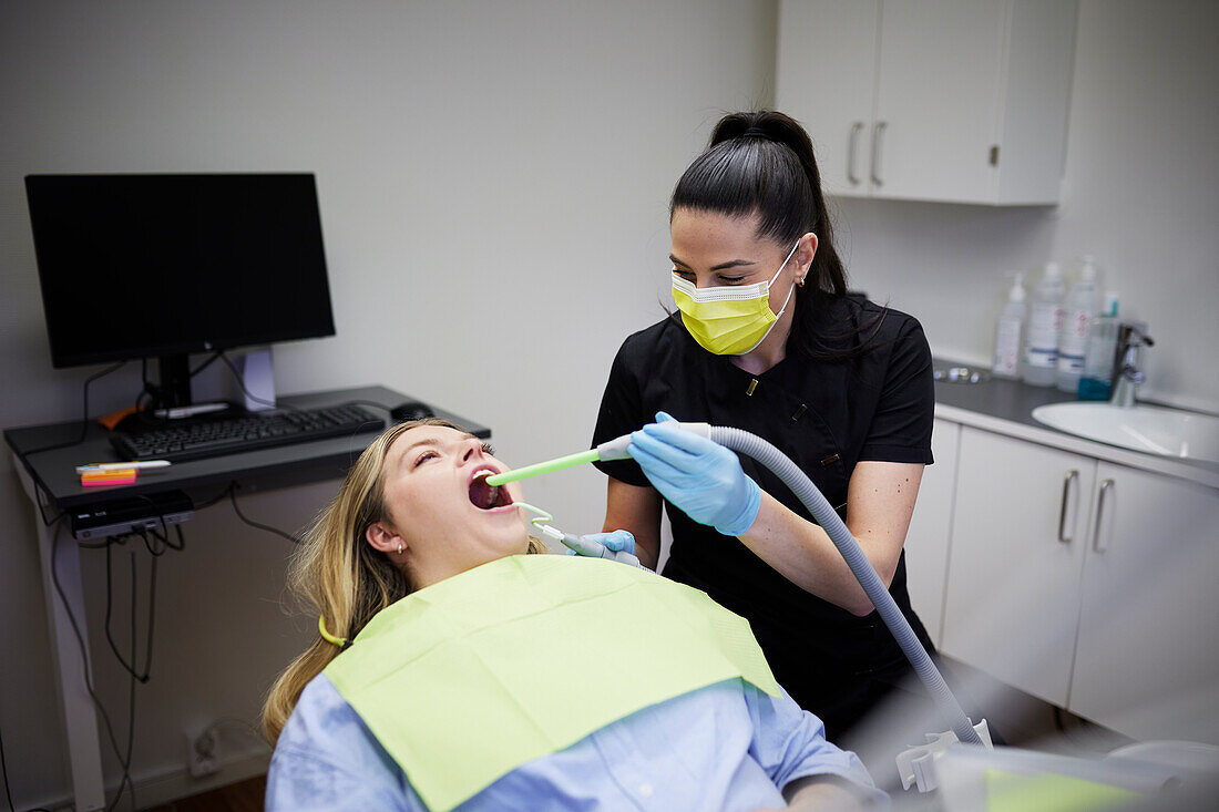 Female dentist with patient in office