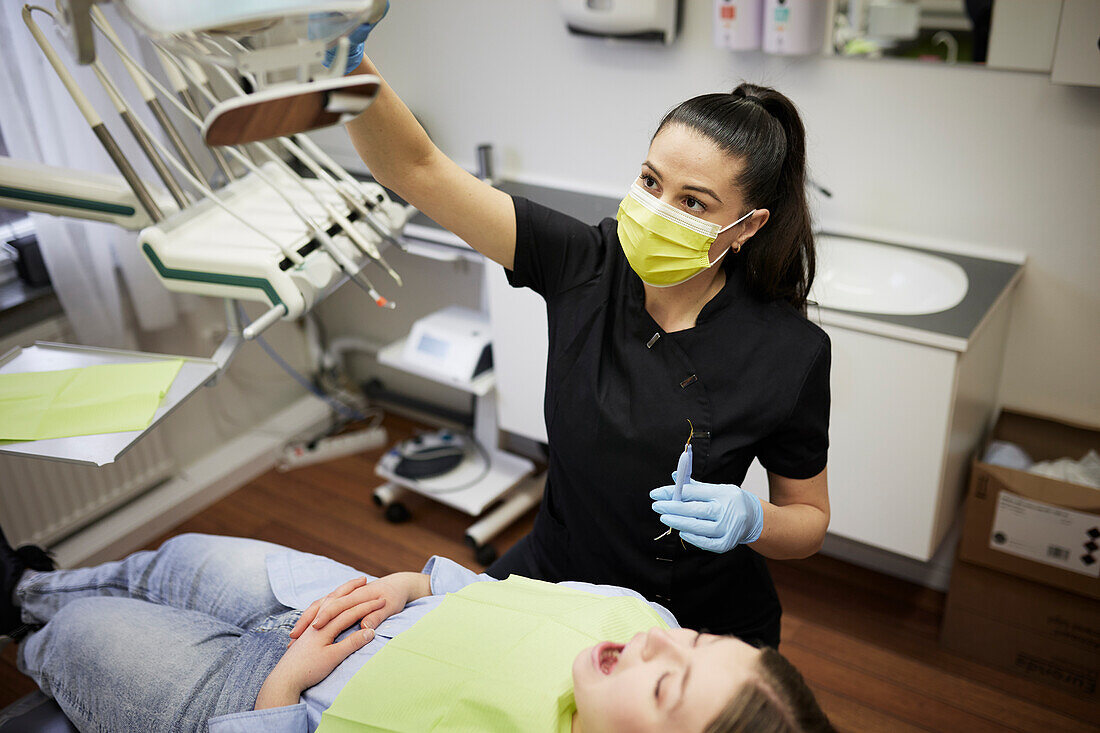 Female dentist with patient in office