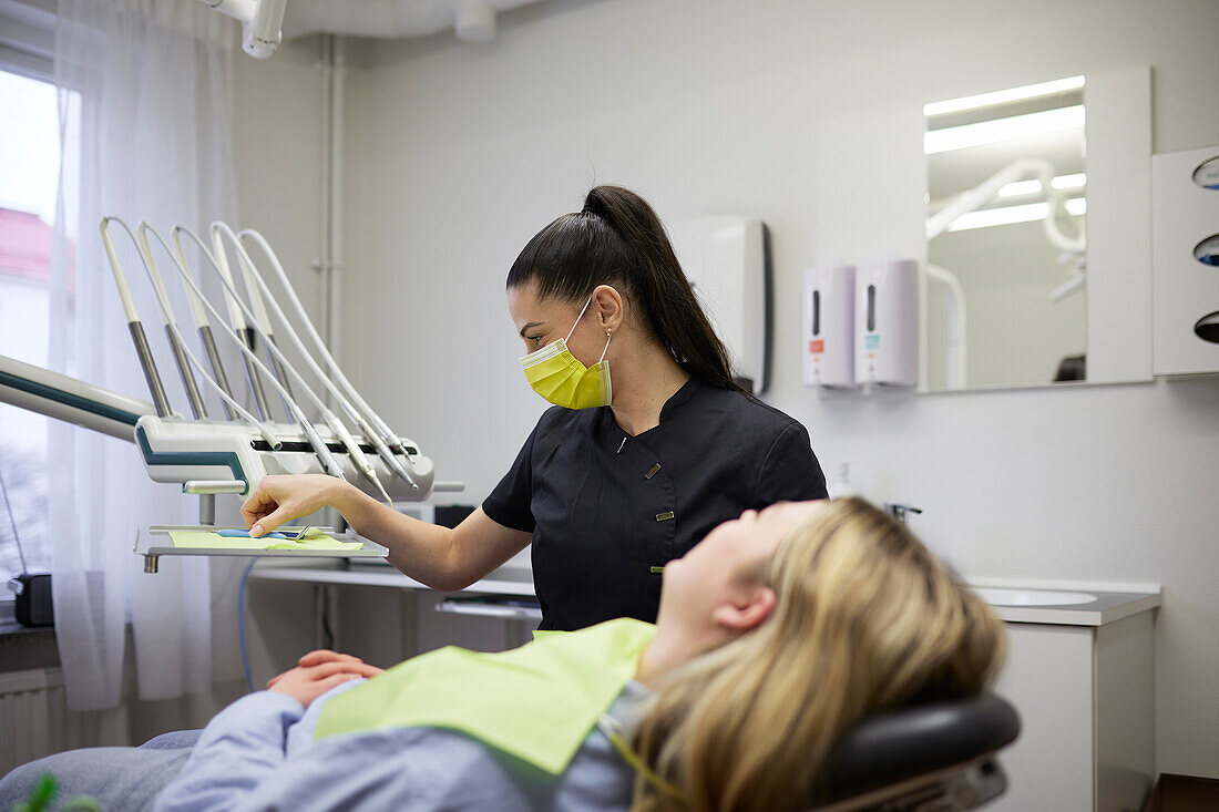 Female dentist with patient in office