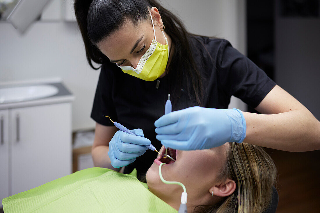 Female dentist with patient in office