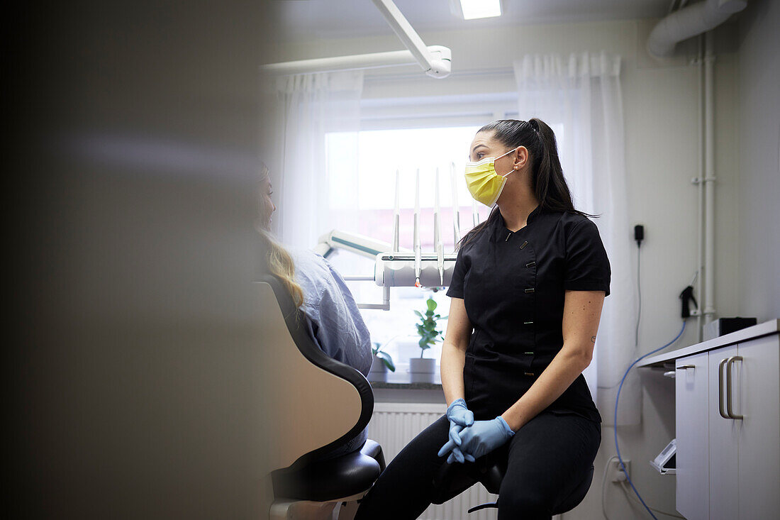 Female dentist sitting in office