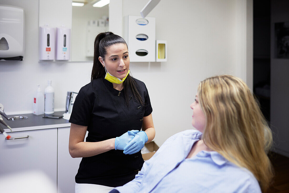 Female dentist with patient in office