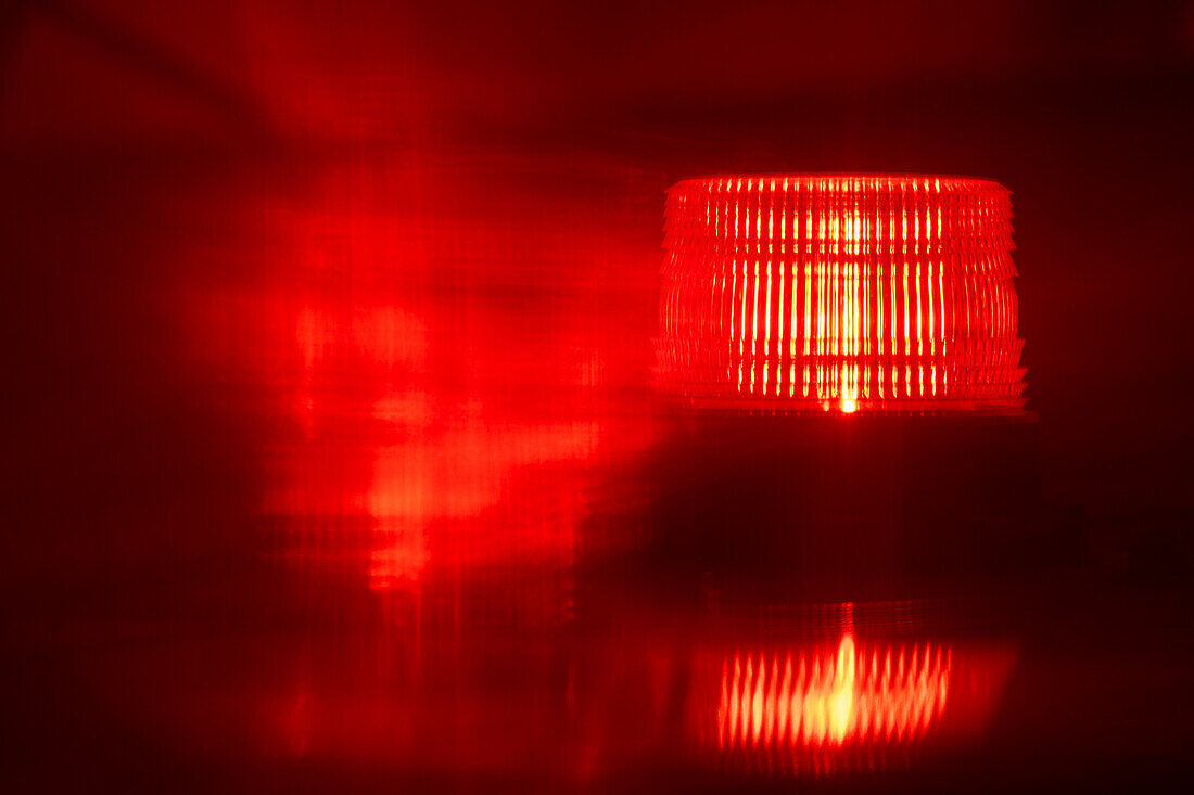 Close-up of flashing red emergency light at night