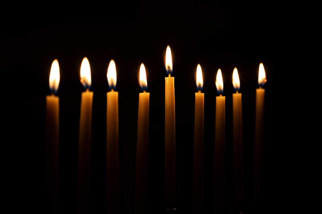 Row of candles against black background