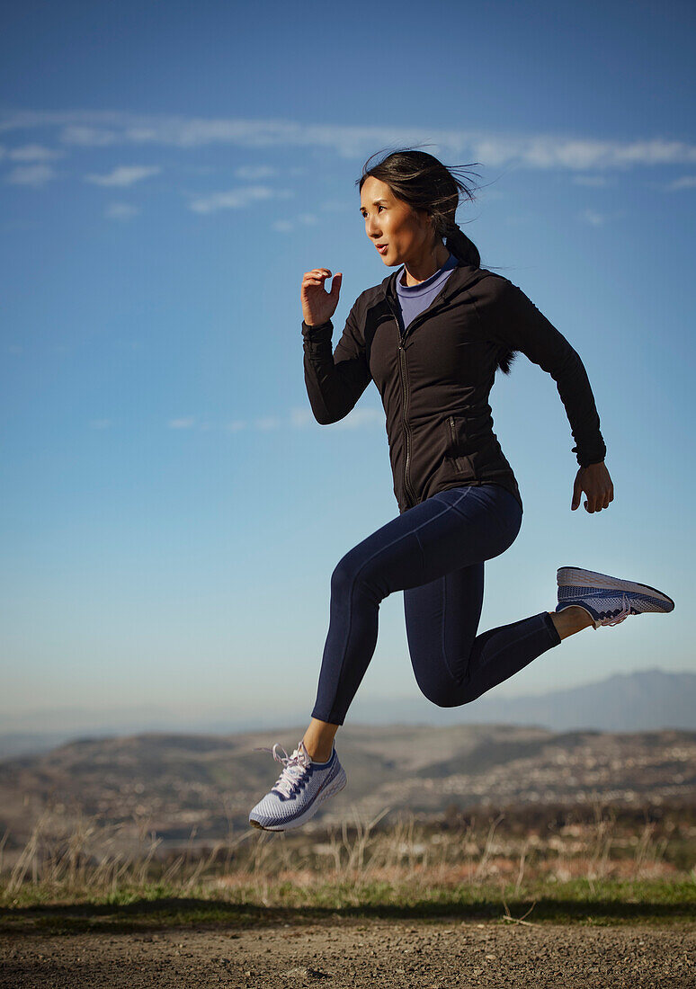 Woman jumping in landscape