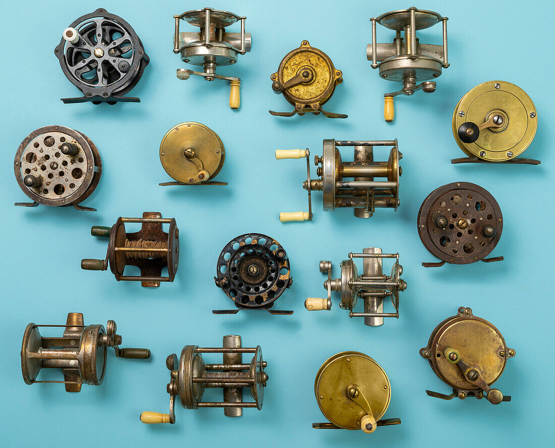 Vintage fishing reels on blue background