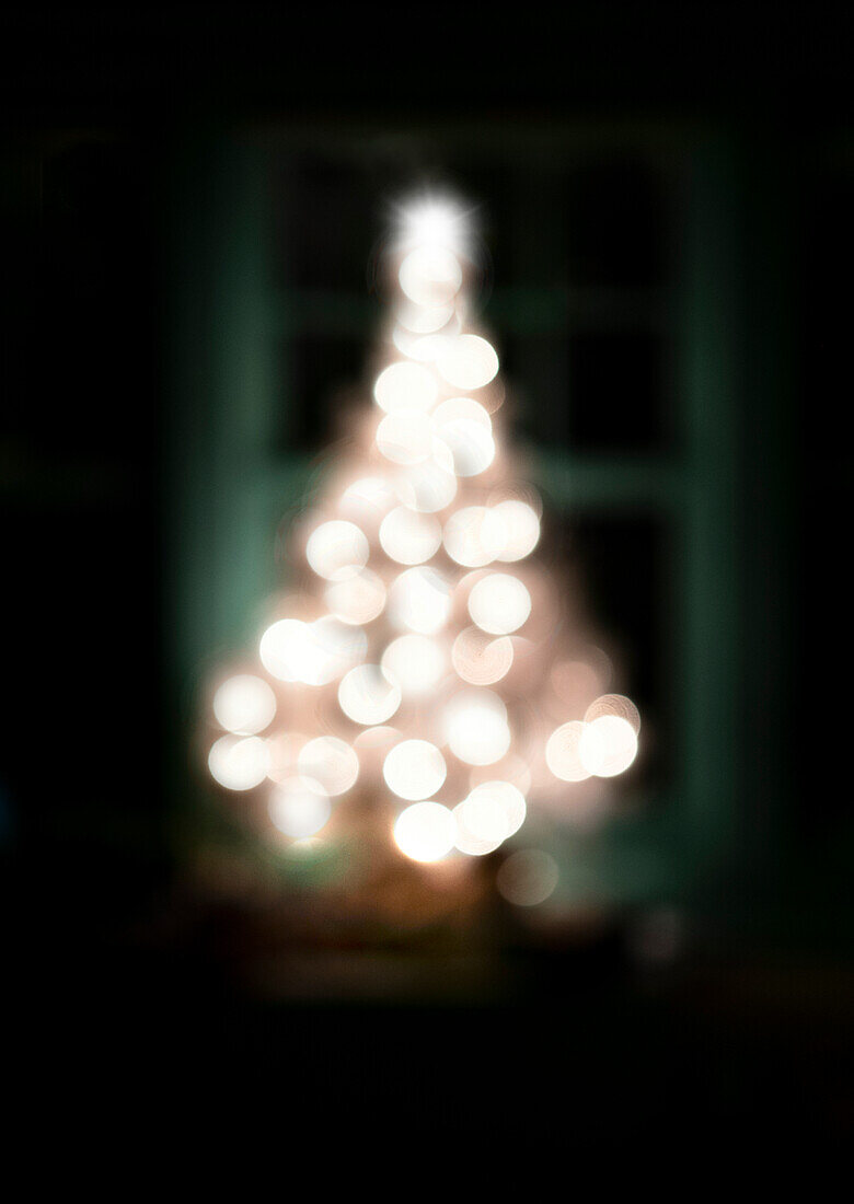 Defocused illuminated Christmas tree at night