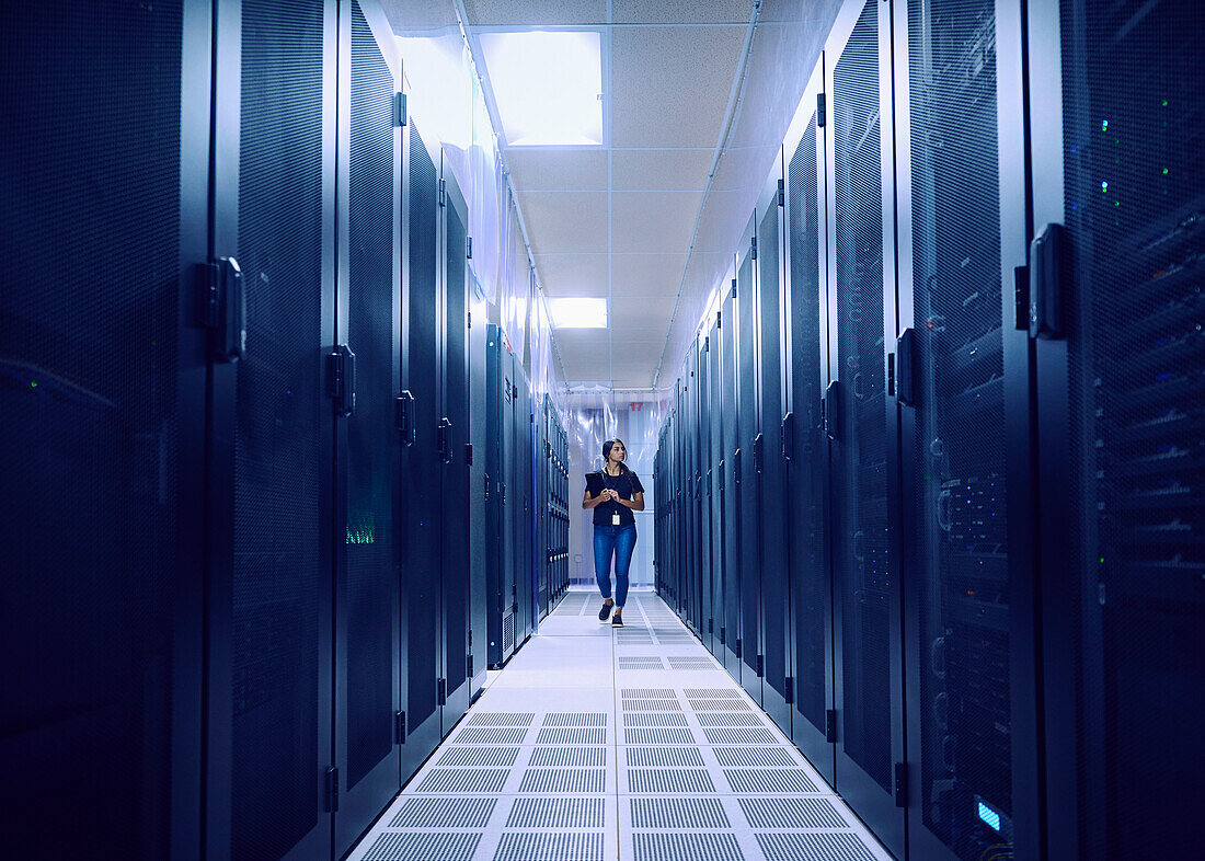 Female technician walking in server room