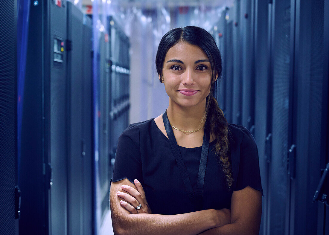 Porträt einer lächelnden Technikerin im Serverraum