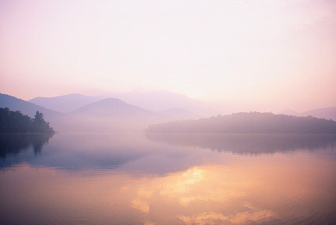 United States, New York, St. Armand, Morning mist rising on Lake Placid, Adirondacks State Park