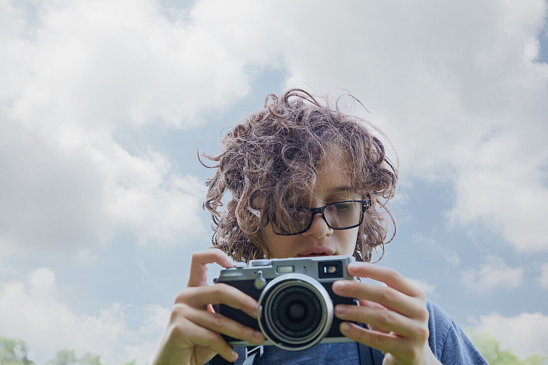 Boy taking picture with camera