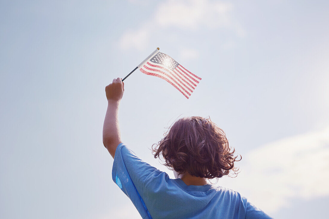 Junge schwenkt amerikanische Flagge