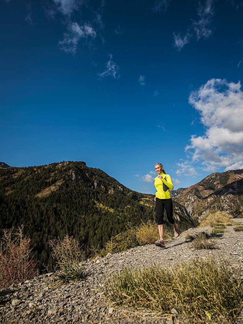 United States, Utah, American Fork, Woman jogging in mountain landscape