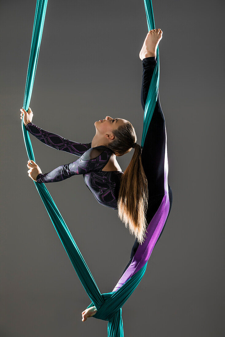 Teenage girl (14-15) practicing aerial silk 