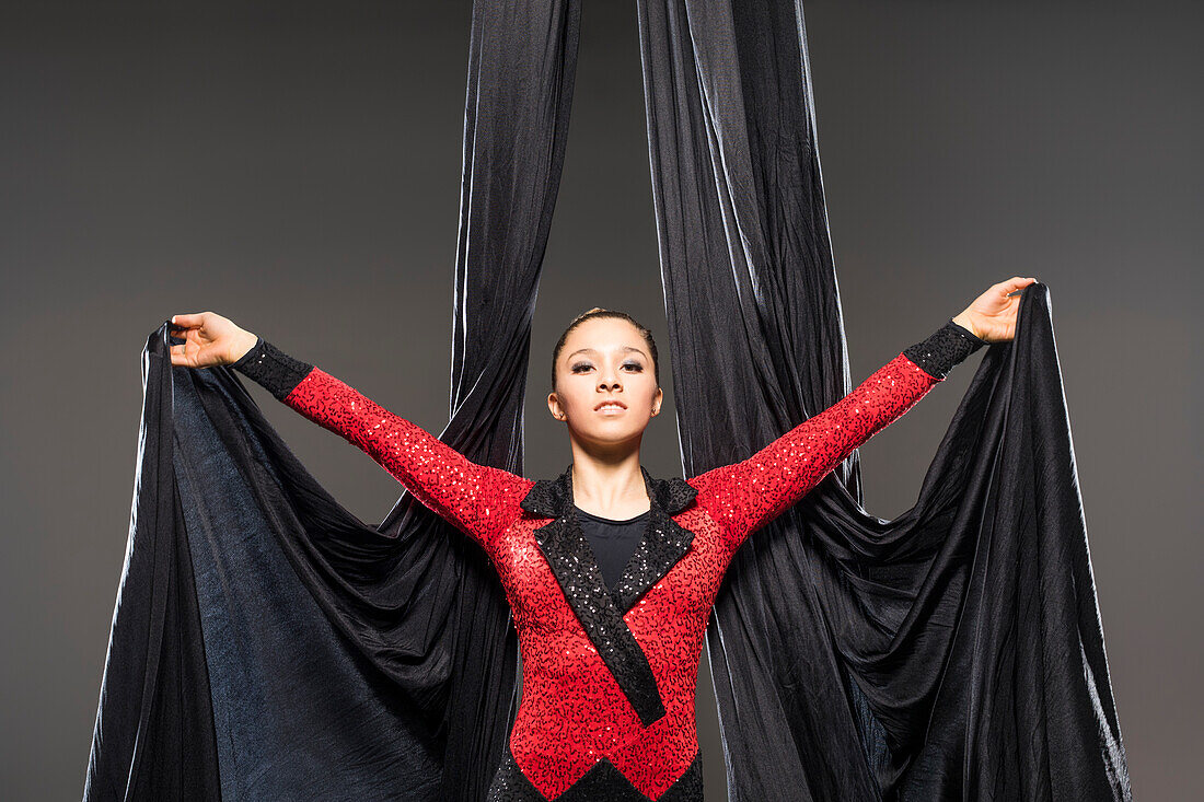 Teenage girl (14-15) performing aerial silk 