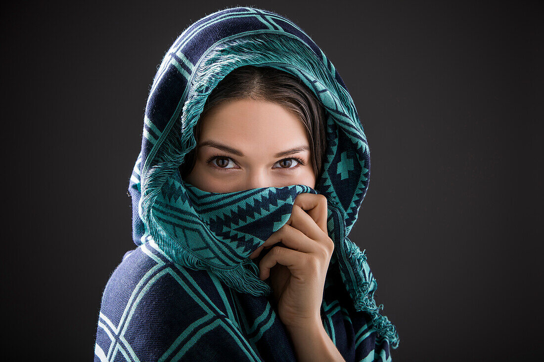 Studio portrait of woman with shawl on head