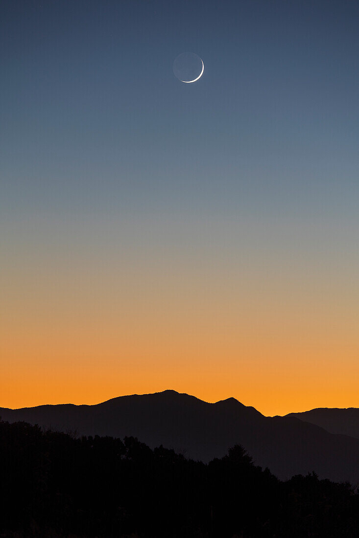 United States, New Mexico, Santa Fe, Crescent moon over Jemez Mountains
