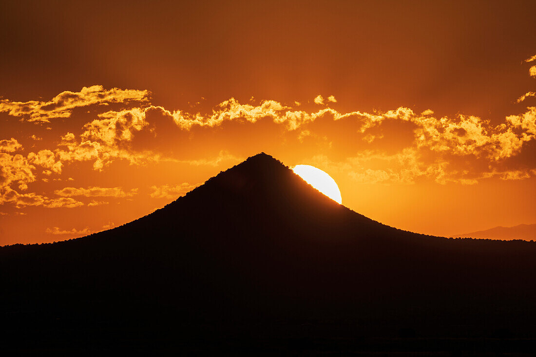 United States, New Mexico, Cerrillos, Silhouette of mountain at sunset in Cerrillos state park